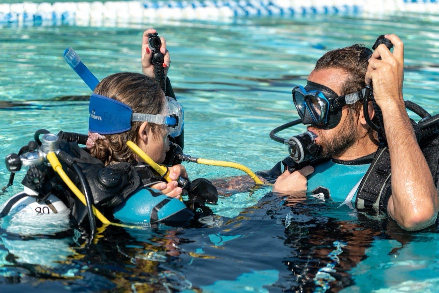 Two divers practising the regulator air-share skill