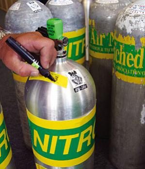 Nitrox scuba cylinders being analysed and labelled