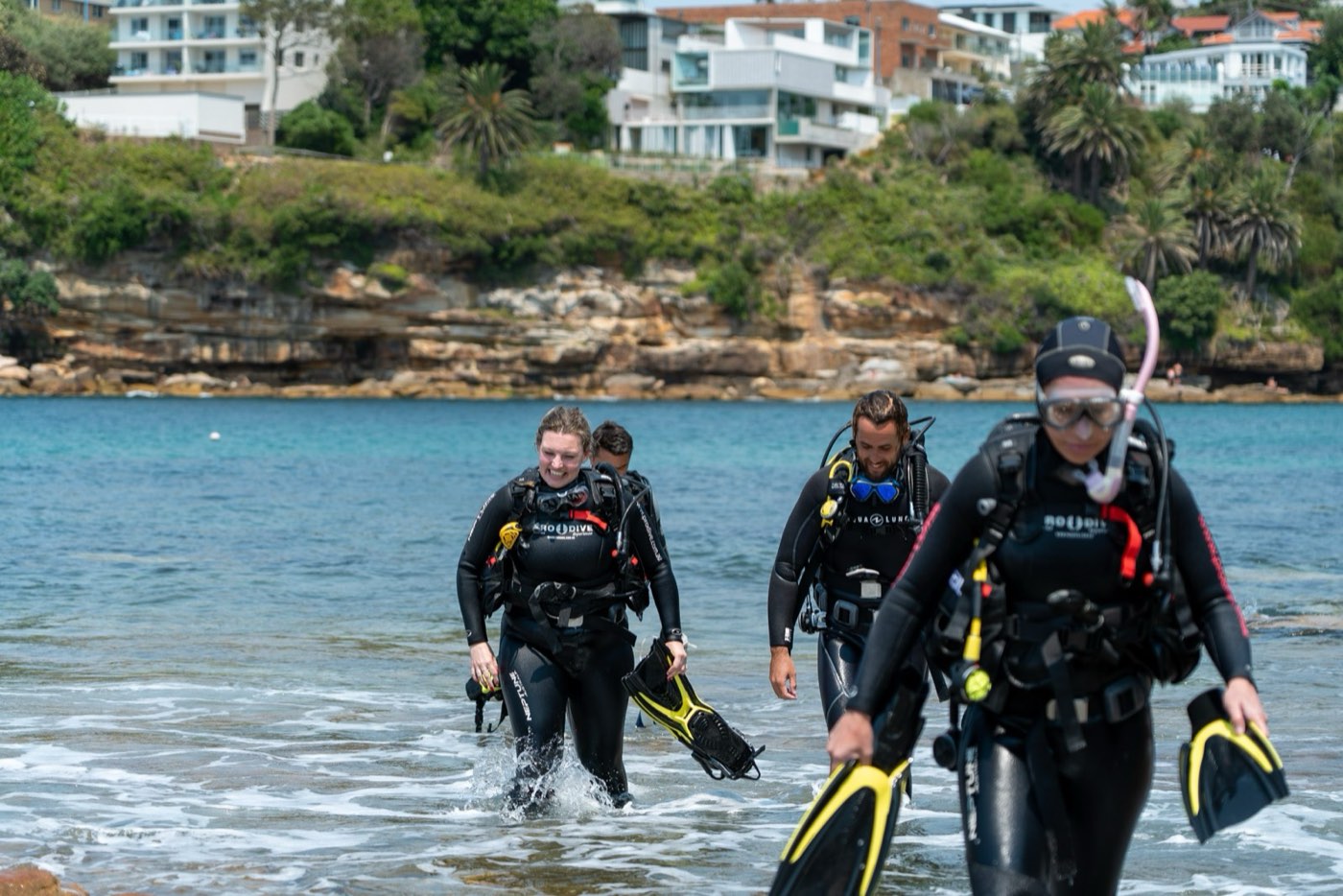 Divers exiting the water at a Sydney shore dive site
