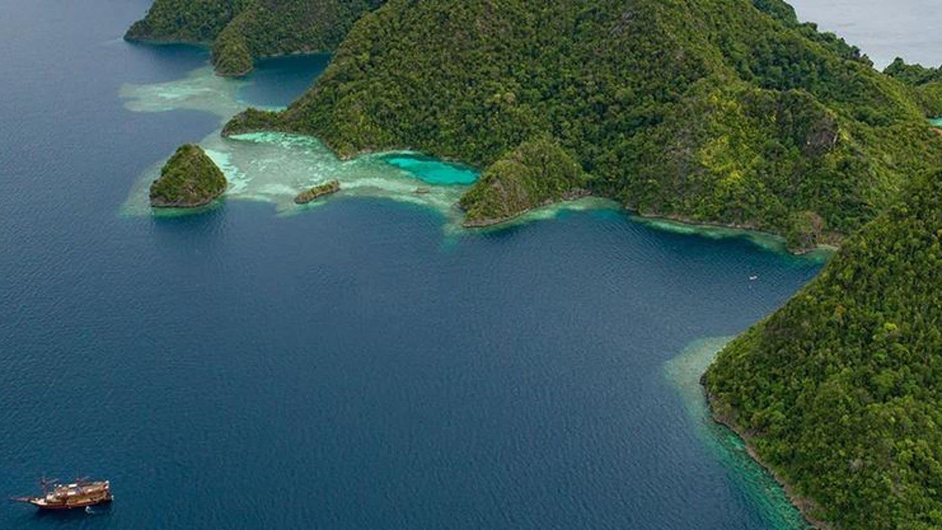 Karst islands and a liveaboard at anchor, Raja Ampat